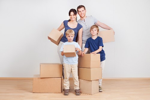 Professional movers handling office items with care in Putney