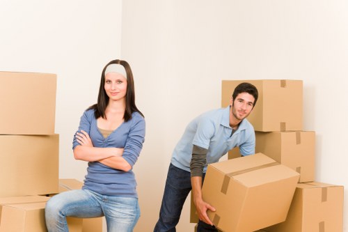 Packed boxes and furniture prepared for moving van transport in Putney