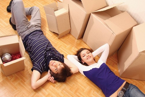 Professional movers carrying furniture for a Putney home move